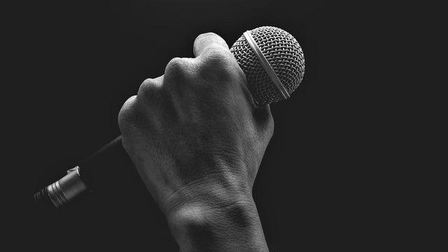 Photo of a hand holding a microphone